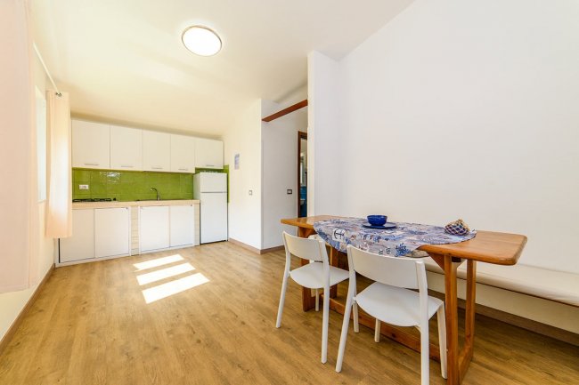 Cucina moderna luminosa con tavolo da pranzo.