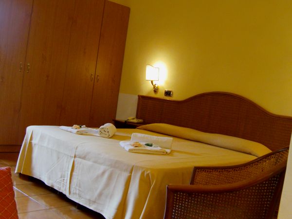 Camera d'albergo con letto matrimoniale e armadio.