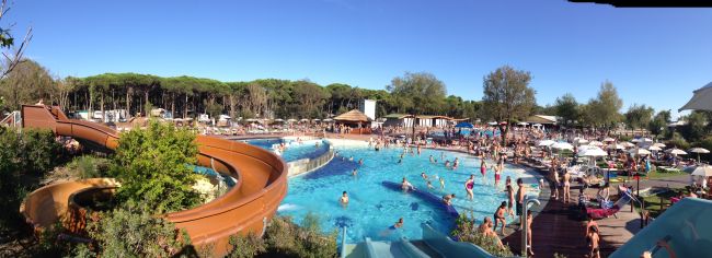 Parco acquatico affollato con scivoli e piscine.